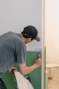 Painter rolling a fresh coat on an interior wall during a Chilliwack home repaint